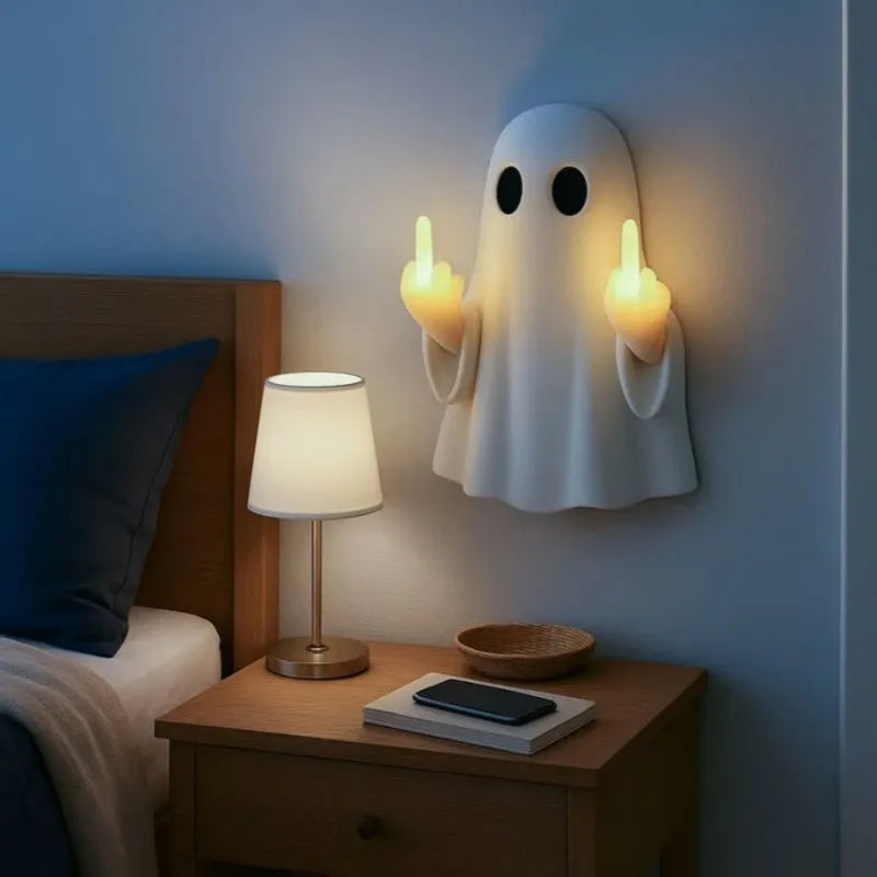 White cute ghost statue plastic night lamp for Halloween decoration on a dark surface.