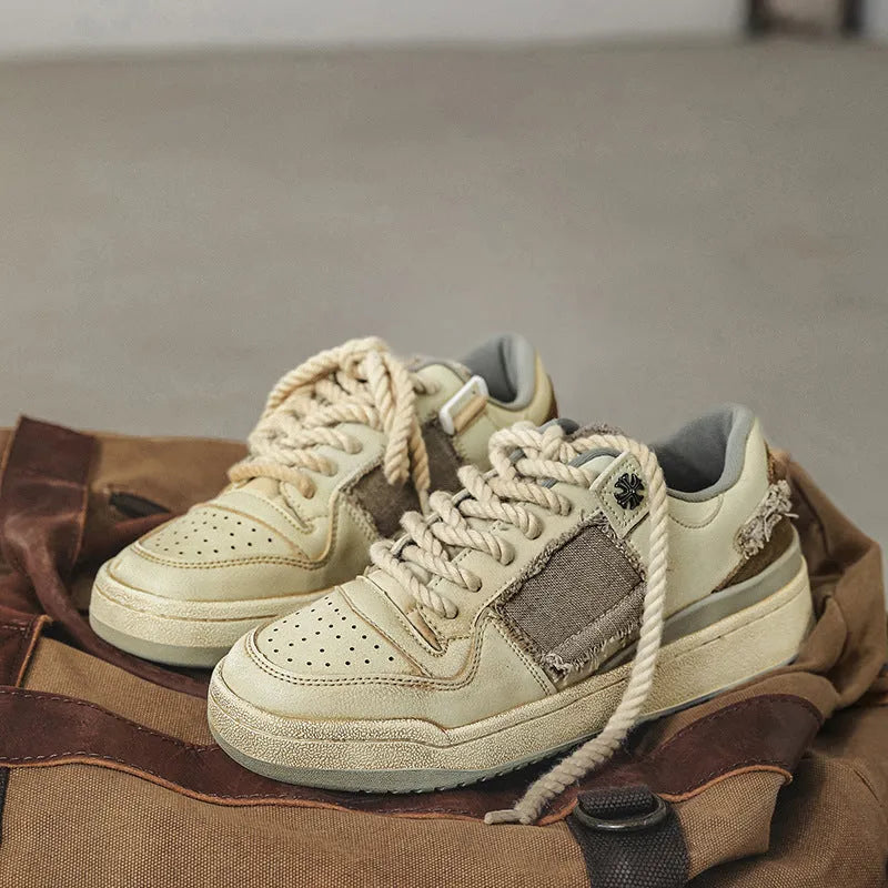 Beige low-top vintage skateboard shoes with microfiber upper and flat rubber sole.