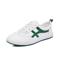 Women's black and white cowhide leather sneakers with elastic band fastening and rubber soles