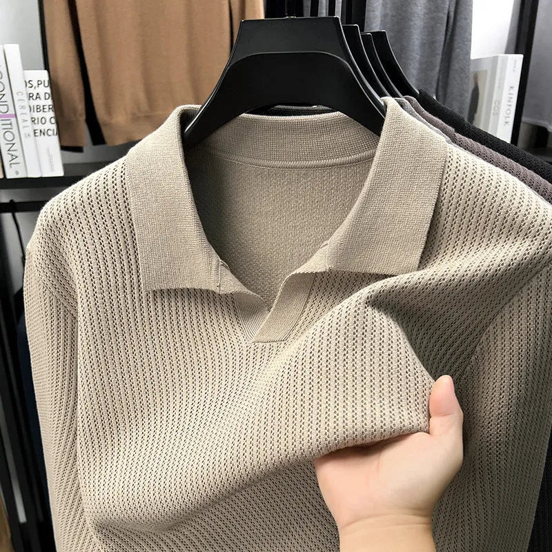 Man wearing a loose green pullover sweater, a casual autumn bottoming layer.