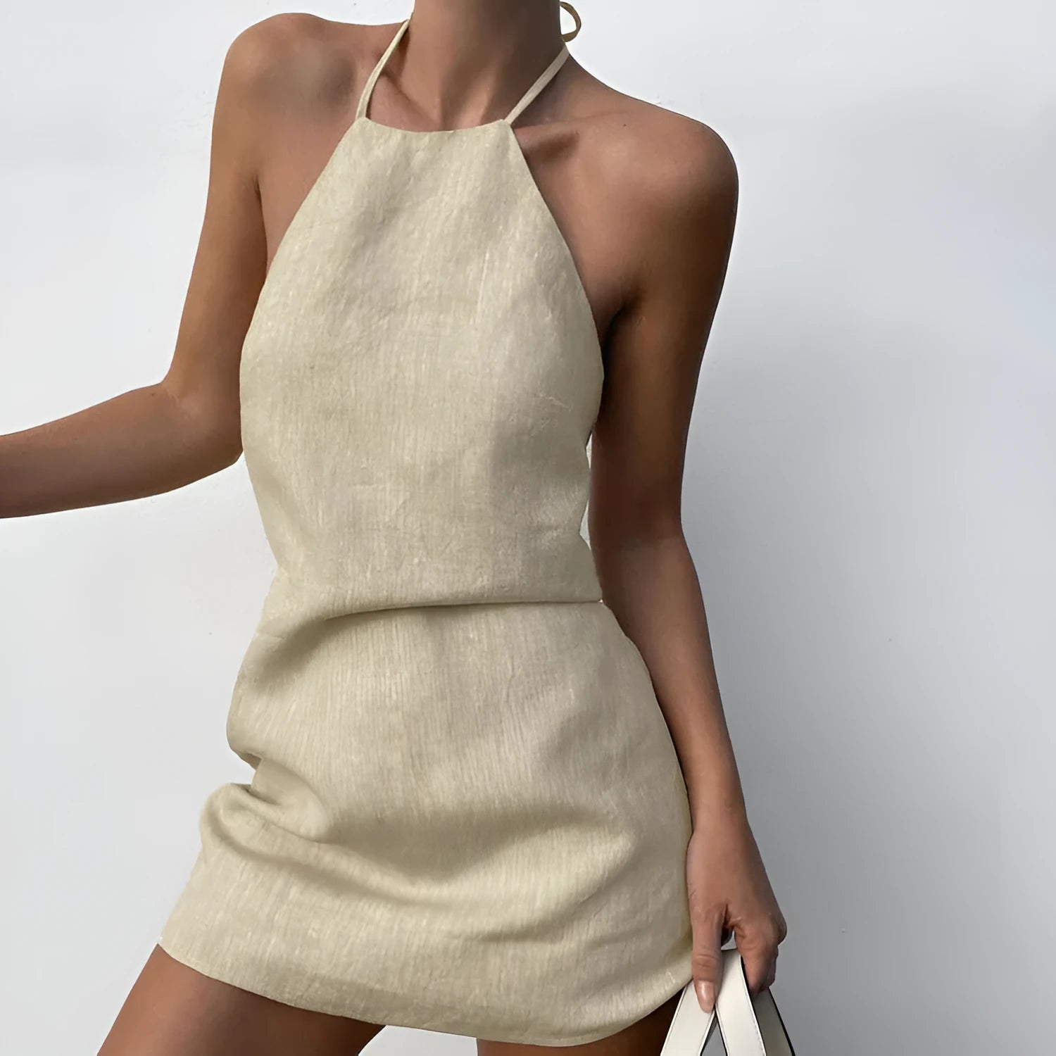 Women's solid colour linen A-line summer dress on hanger showing midi length and casual design