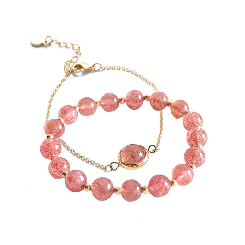 Close-up of a women's double-layer copper bracelet with lucky beads and an electroplated gold finish in a strawberry quartz colour.