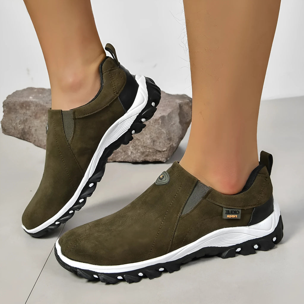 Men's grey slip-on shoe cover with round toe and rubber sole, shown from the side.