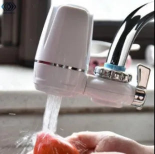 White plastic faucet water filter with ceramic cartridge and universal tap adapter kit.