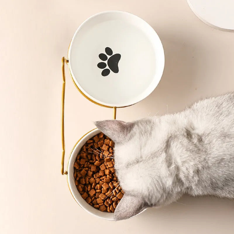 White ceramic pet bowl with iron frame featuring cat ear design, decorated with cat footprints pattern