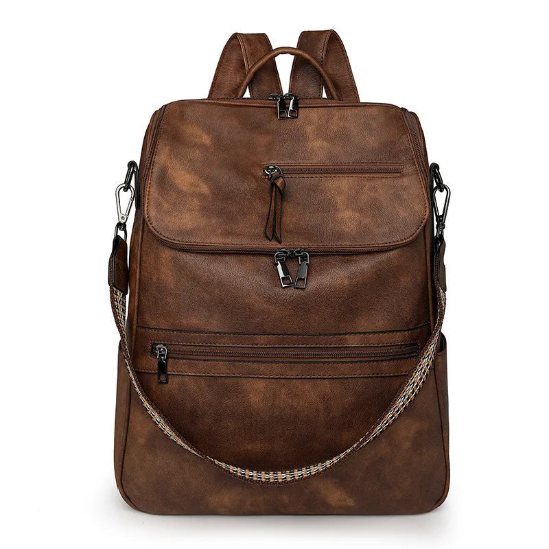 Solid-colour university backpack in PU leather with curved shoulder straps and minimalist stitching detail