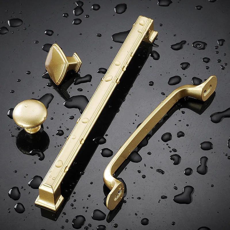 Brushed gold T-shape cabinet handle for single-hole furniture mounting.