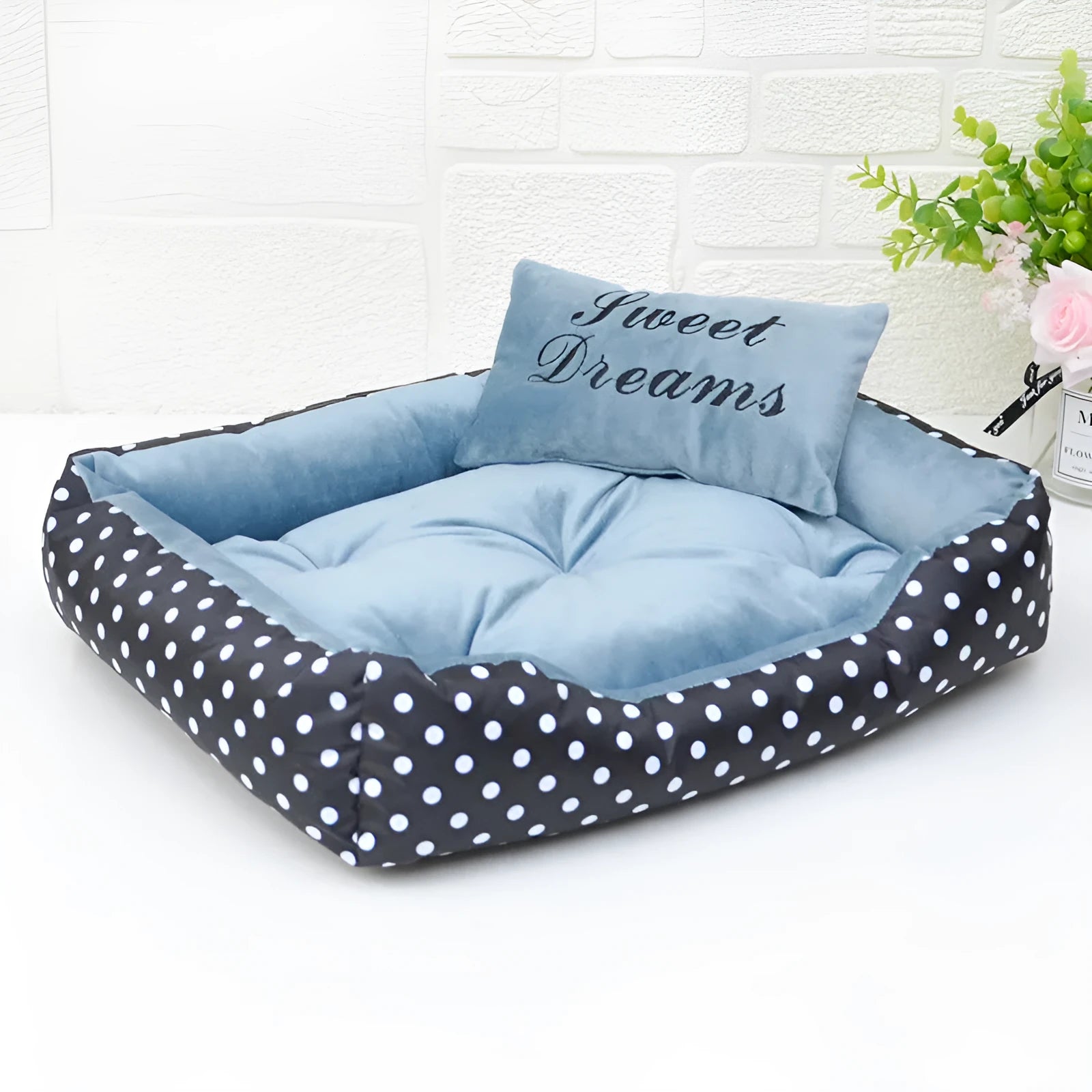 Small polka dot print square dog bed with a matching square pillow inside, shown in grey colour.
