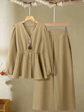 Women's woven polyester two-piece suit in wine red with button-front long-sleeved top and matching full-length trousers