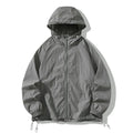 Loose fit unisex outdoor sports jacket in nylon blend fabric on a hanger.