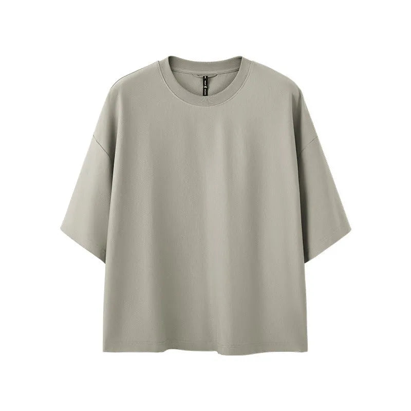 Man wearing a loose-fit Sand Grey short sleeve t-shirt made from cotton-polyester blend.