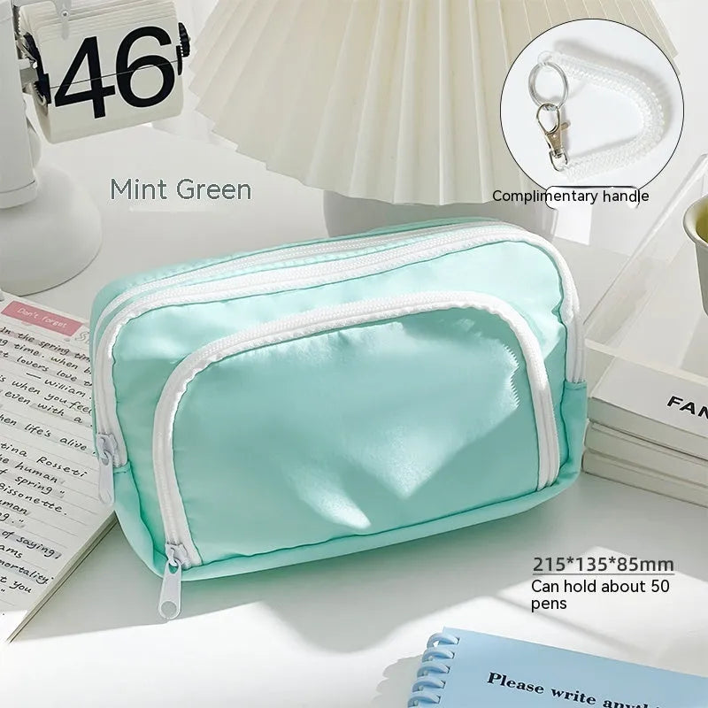 Double layer pencil case in solid colour with gift handle showing interior compartments