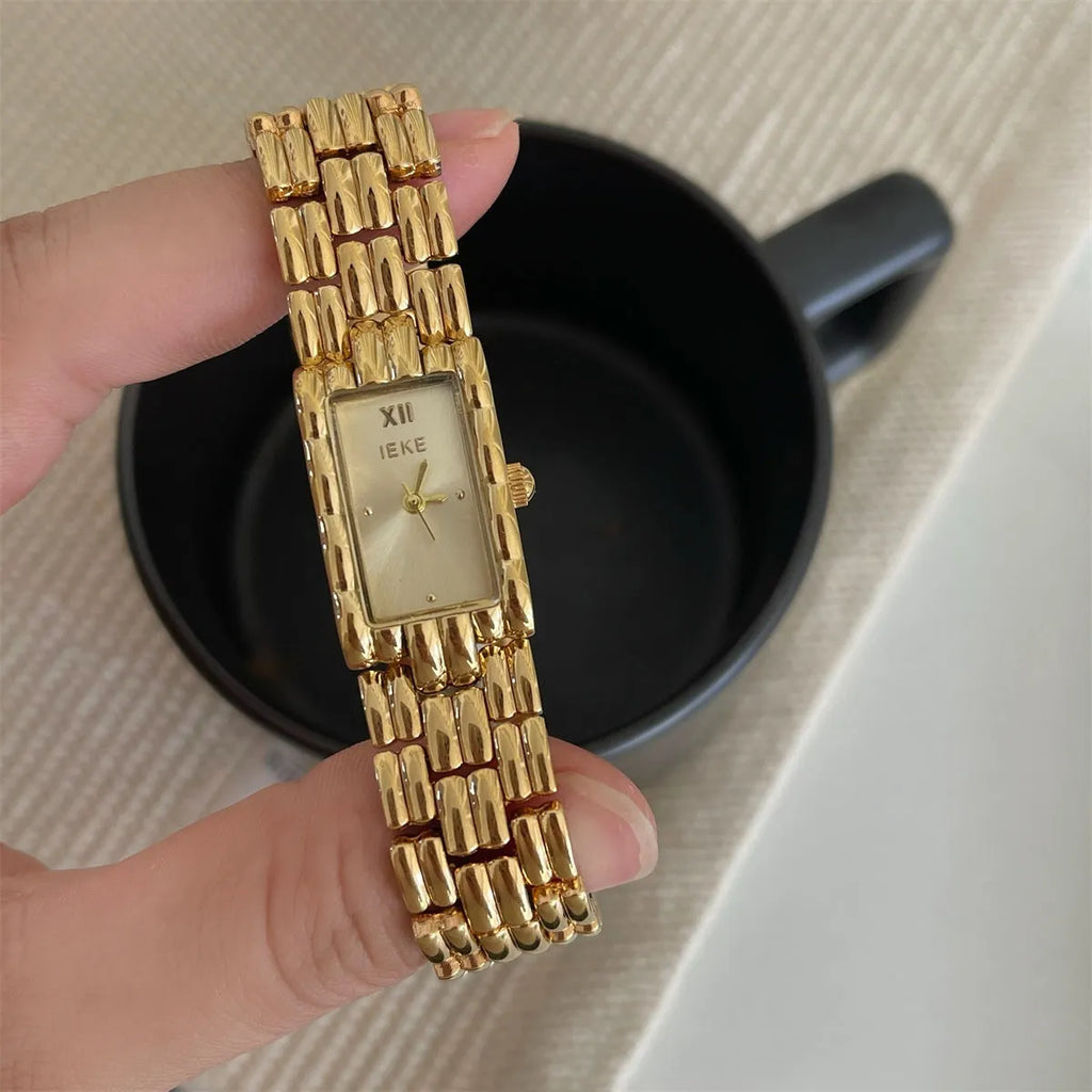 Women's stainless steel analogue watch with a butterfly clasp, showing a silver bracelet and white dial.