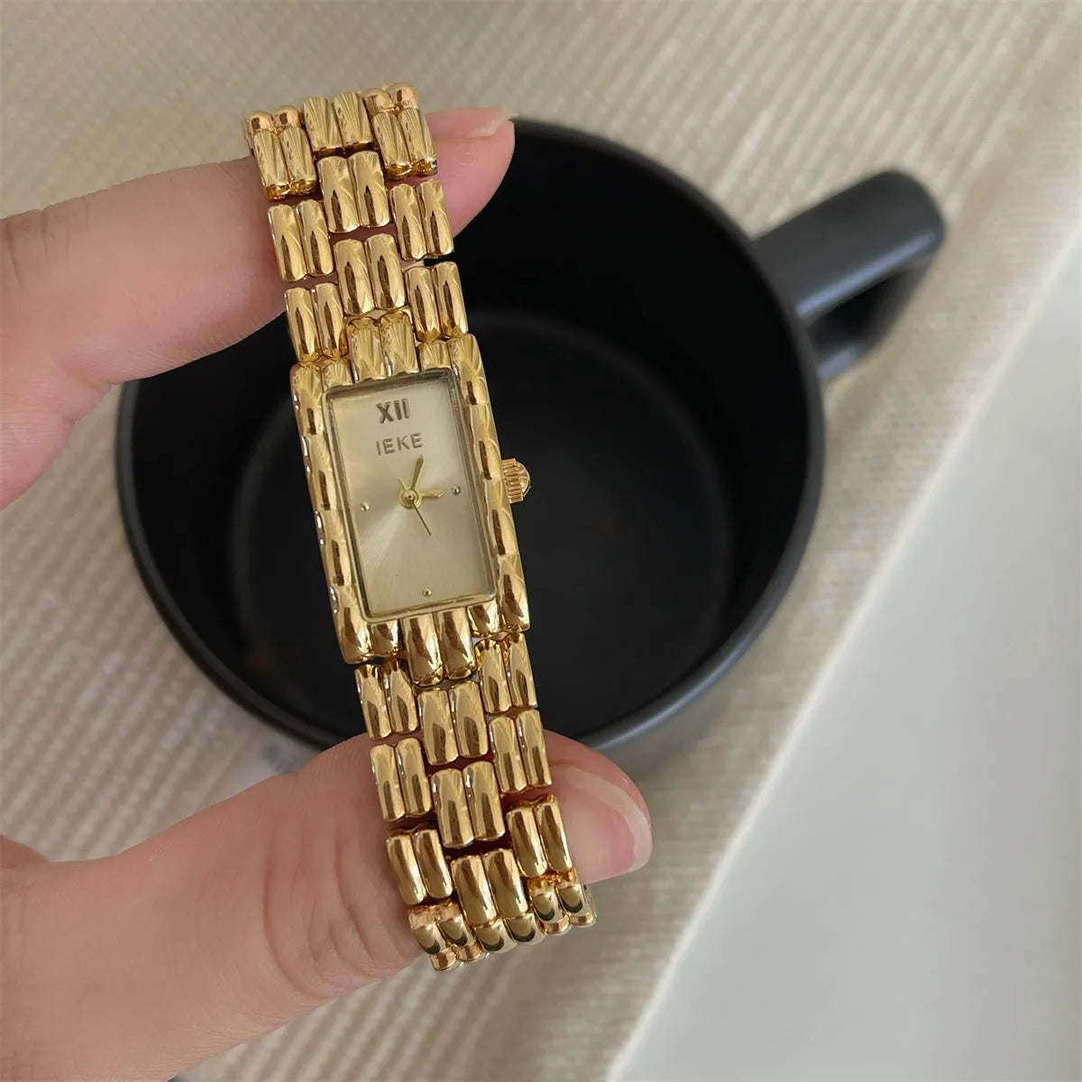 Women's stainless steel analogue watch with a butterfly clasp, showing a silver bracelet and white dial.