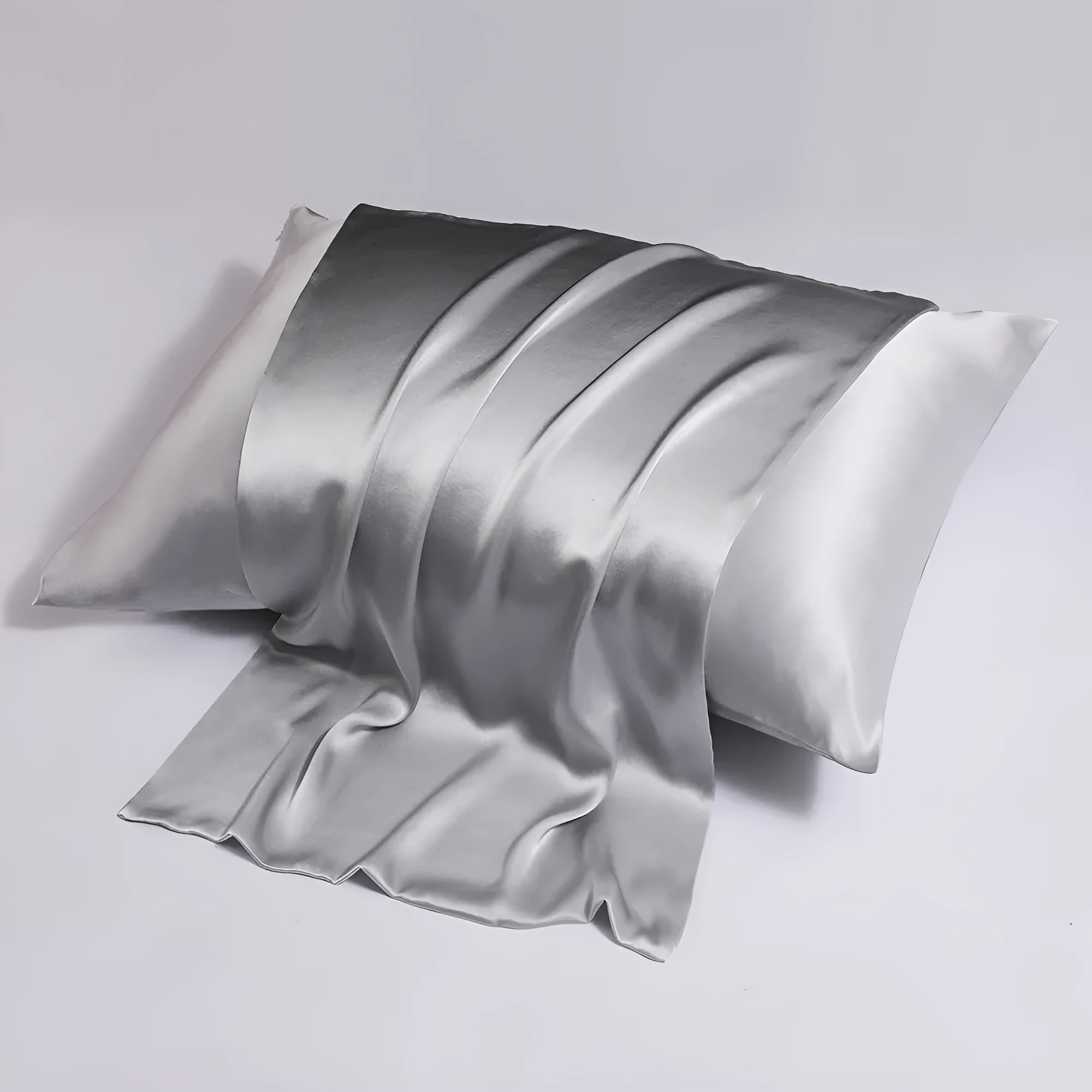 Double-sided zipper pillowcase in mulberry silk showing two colours, with close-up of concealed zip pull tab.