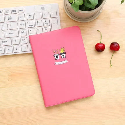 Leather handbook notebook 36K with 112 beige pages closed, showing blue red and white colour options