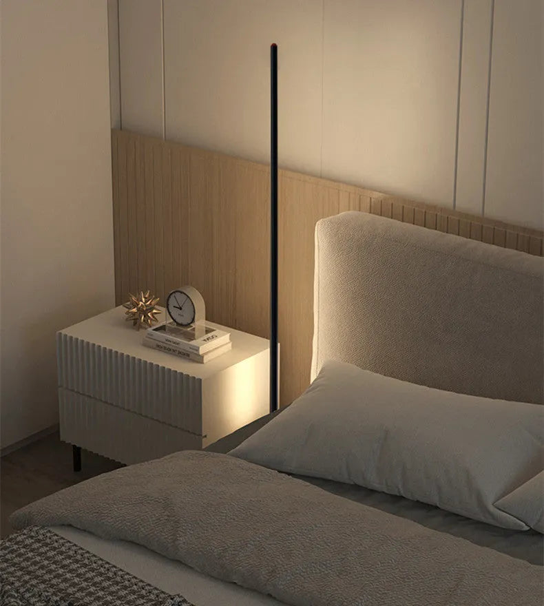 Simple modern vertical aluminium alloy floor lamp with LED light in a living room corner.