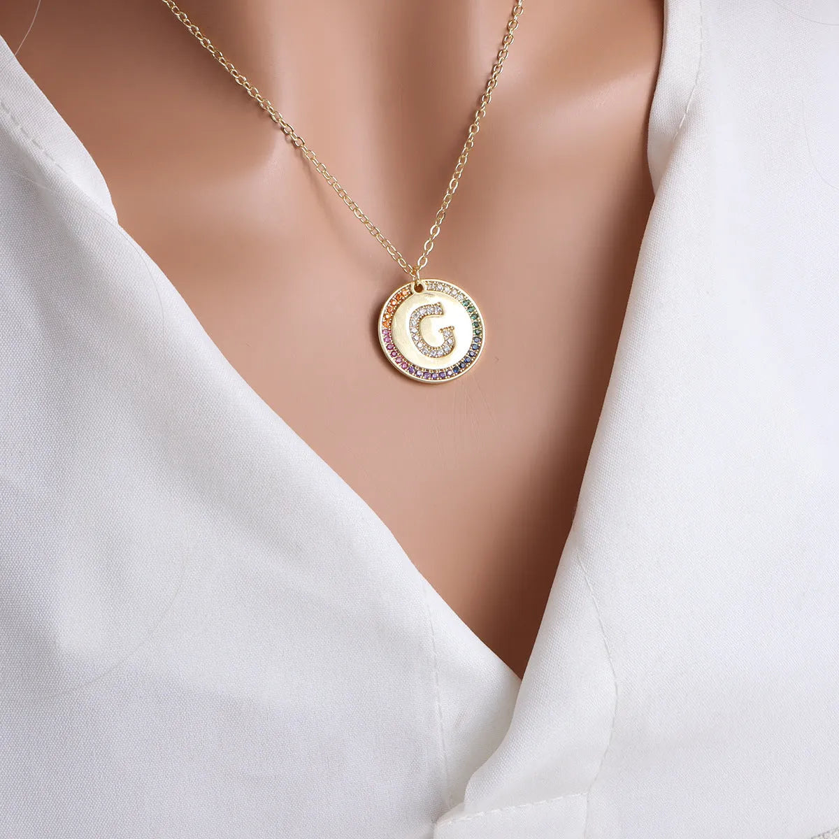 Gold English letter round pendant necklace with colourful crystals on clavicle length chain