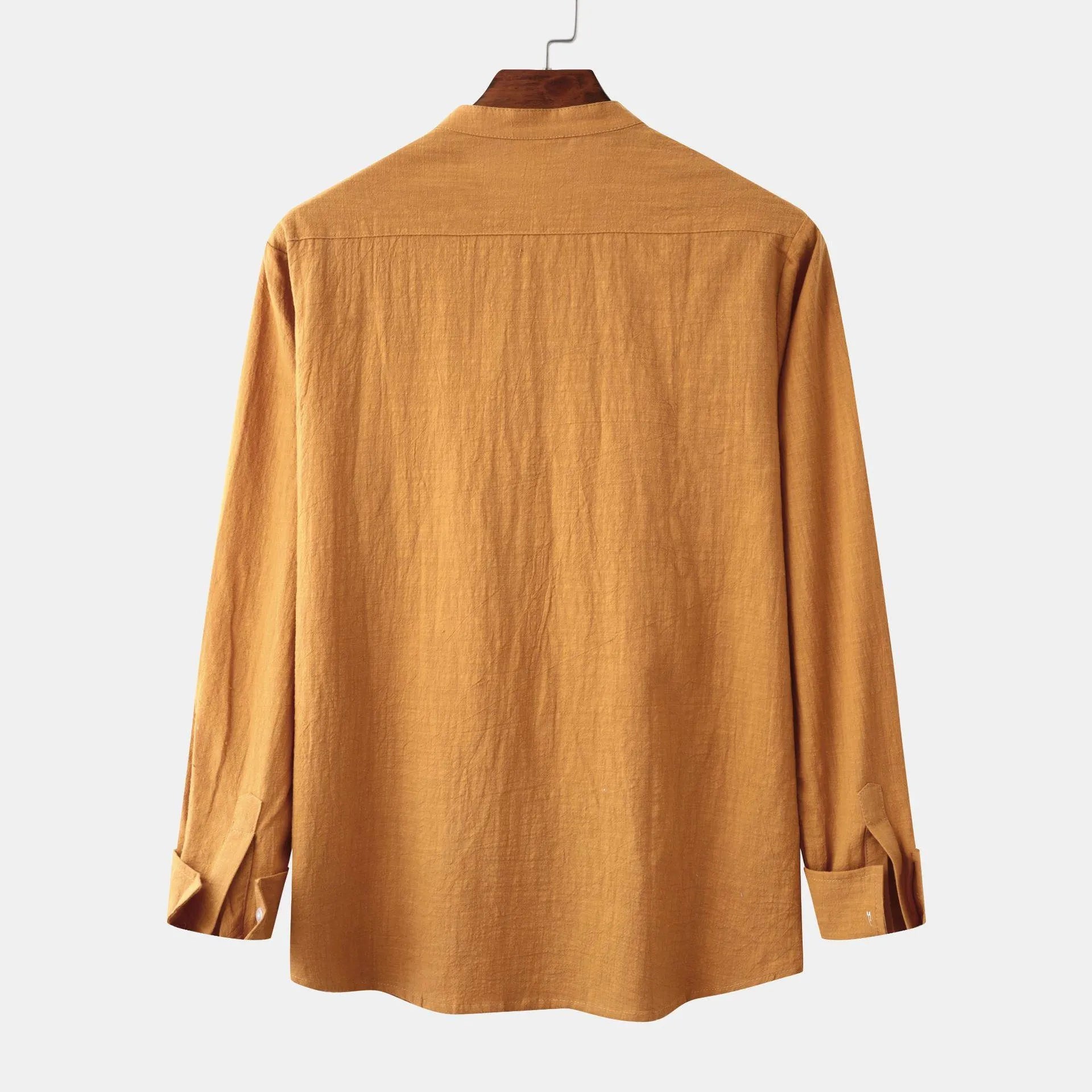 Brown men's slim fit long sleeve shirt and casual trousers on a hanger.