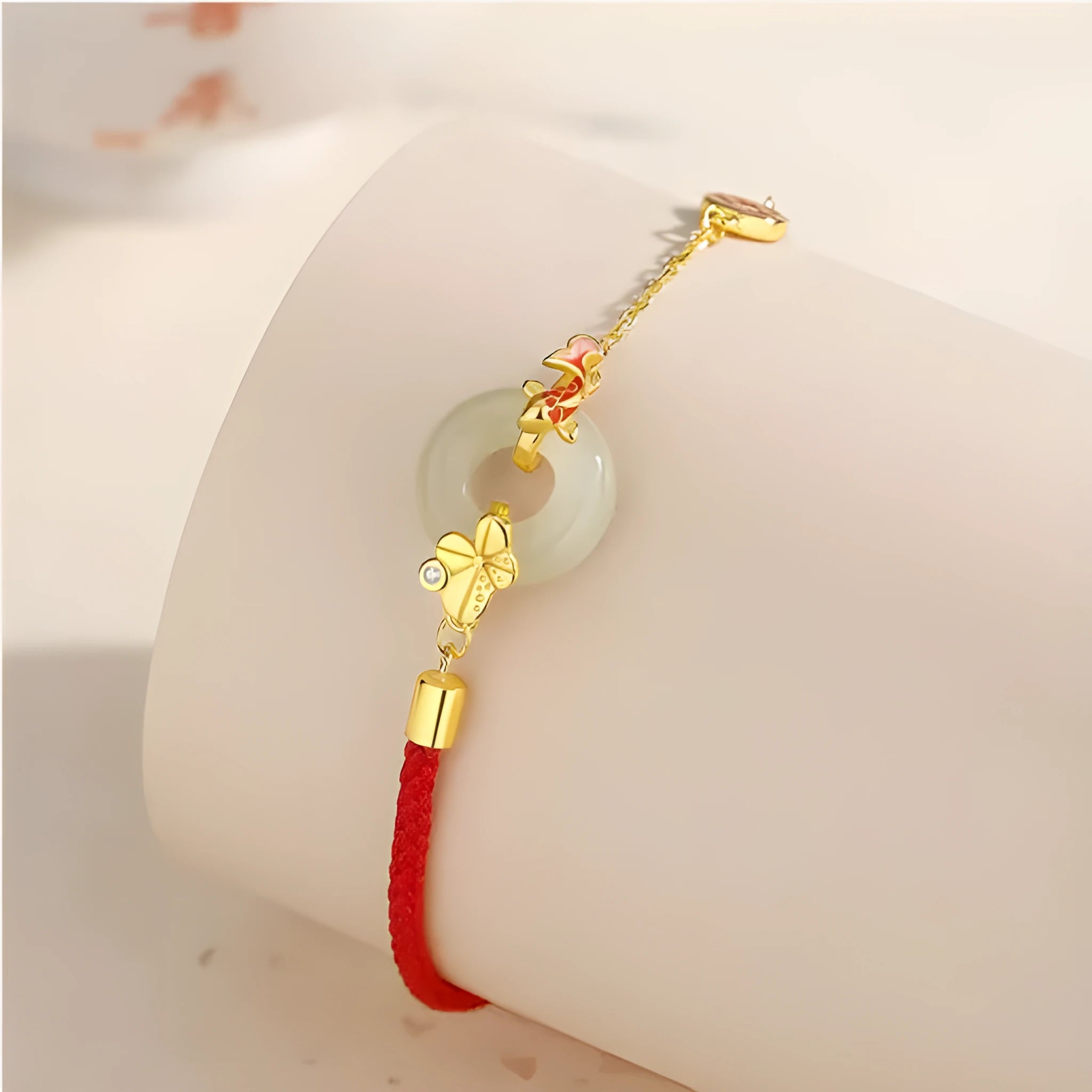 Gold koi peace buckle bracelet made from 925 silver with red rope closure