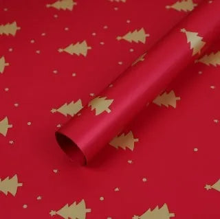 Christmas Kraft paper gift wrap sheets with red and green ink printed cartoon designs including polka dots, snowflakes, and Christmas trees
