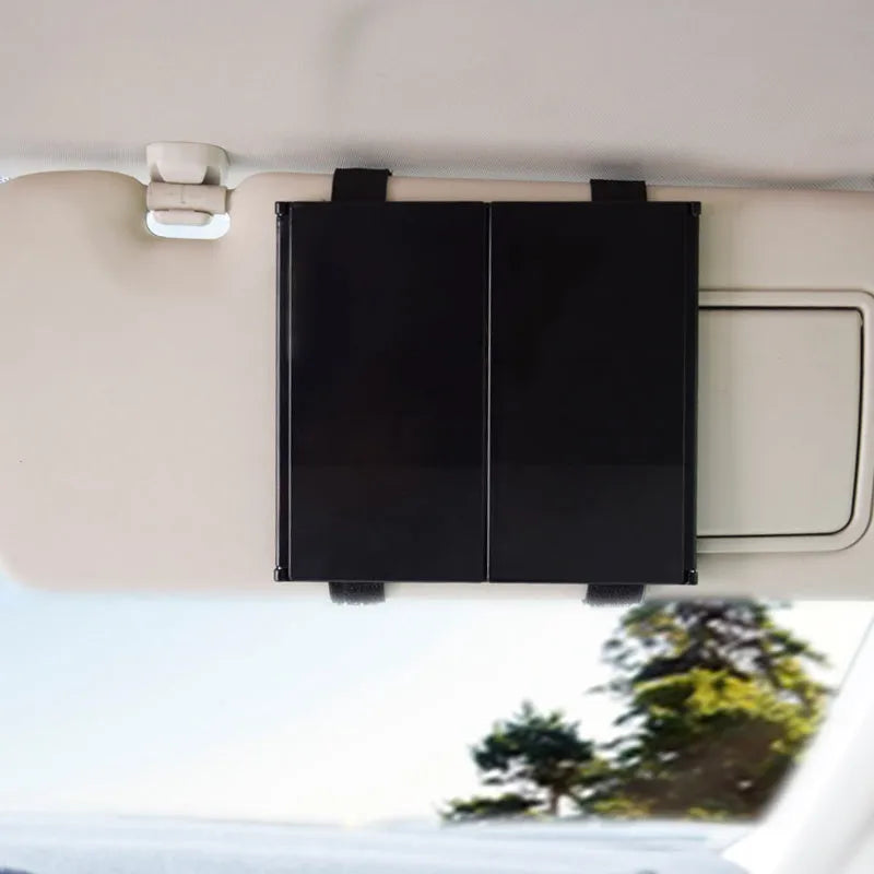 Silver folding car makeup mirror shown both closed and open on a car visor.