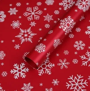 Christmas Kraft paper gift wrap sheets with red and green ink printed cartoon designs including polka dots, snowflakes, and Christmas trees