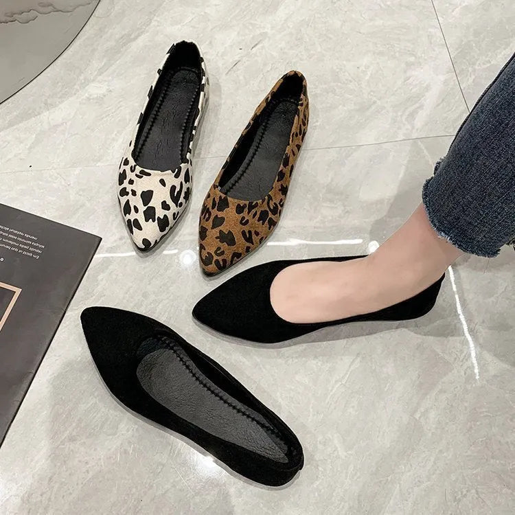 Women's leopard print flat pumps with a pointed toe, low heel, and cotton upper on a rubber sole.