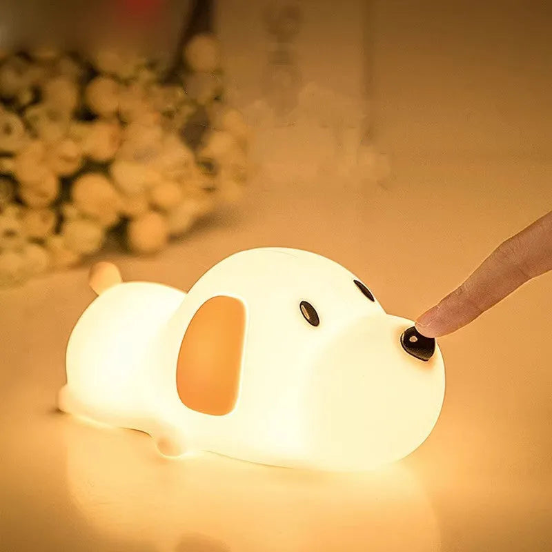 Cute silicone dog night lamp with two-color USB charging light on a wooden table
