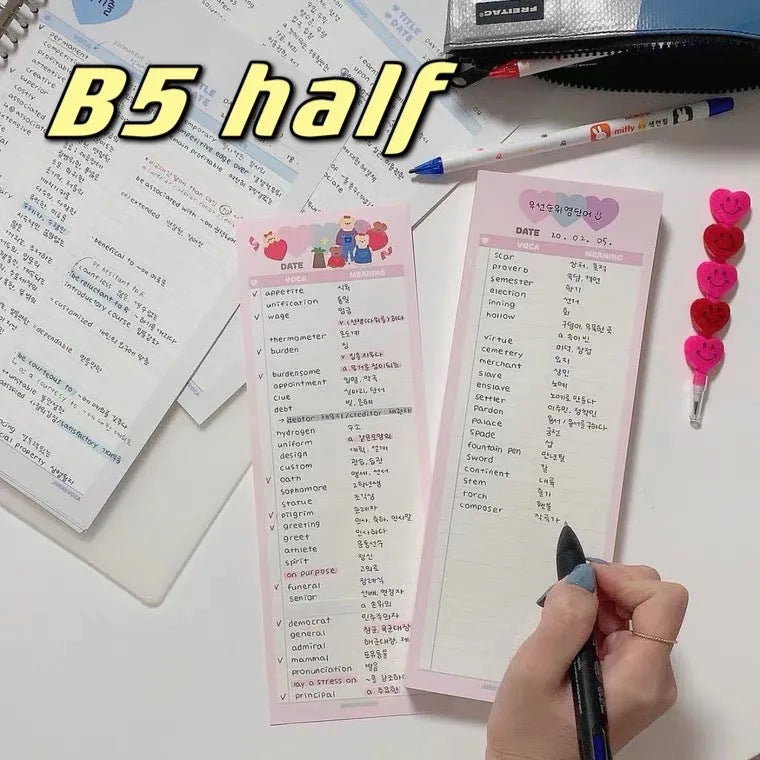 Half-B5 size vertical notepad with coloured cover, shown open to show lined pages.