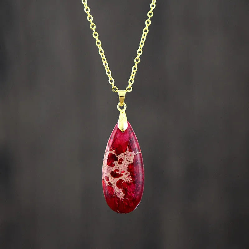 Emperor Stone water drop pendant necklace with genuine jade centre and 18K gold plated setting on a chain.