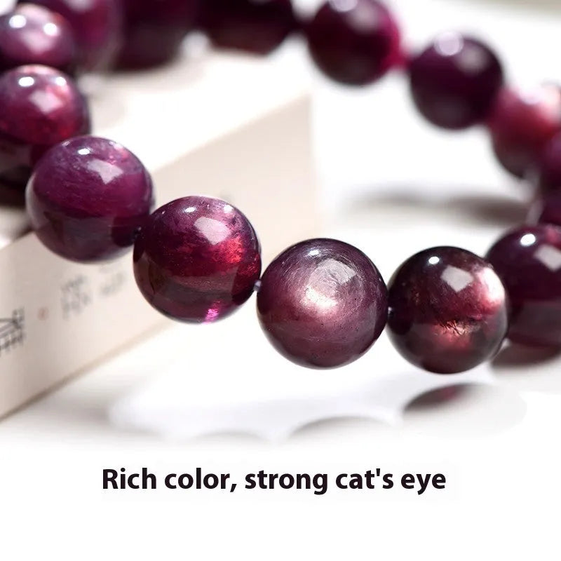 Natural purple lepidolite crystal bracelet with polished round beads on a white background.