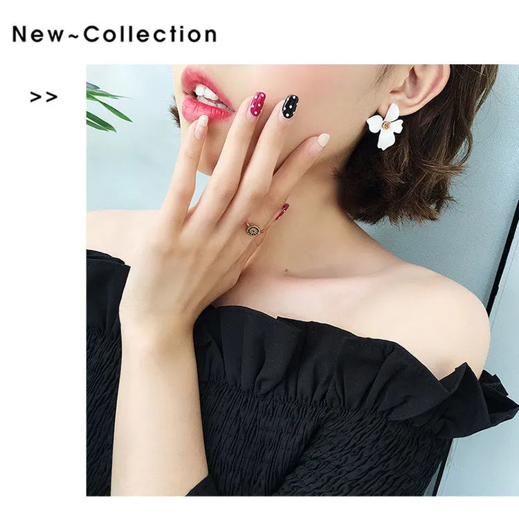 A pair of small floral-shaped stud earrings in alloy, shown in pink and white colour options.