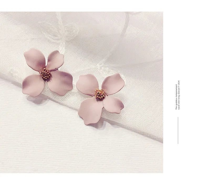 A pair of small floral-shaped stud earrings in alloy, shown in pink and white colour options.