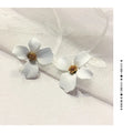 A pair of small floral-shaped stud earrings in alloy, shown in pink and white colour options.