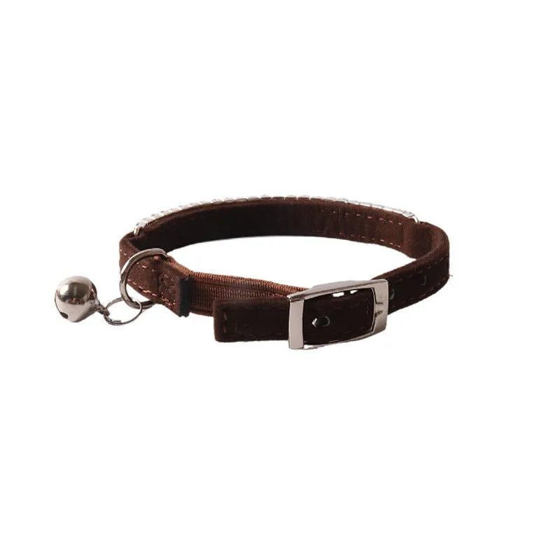 Soft pink flocked cat collar with an elastic section and silver buckle on a 1.0cm wide, 28cm long band.
