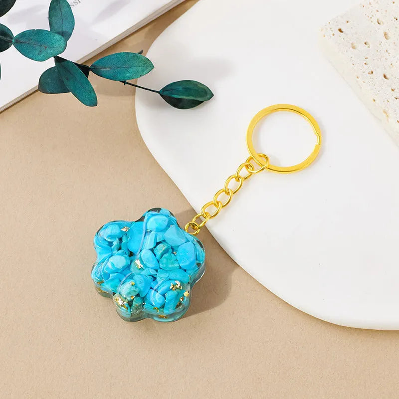 Small natural crystal cat's paw pendant on a metal keyring, available in various stone colours.