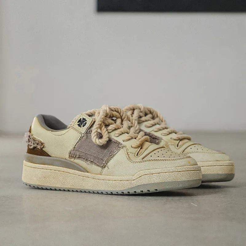 Beige low-top vintage skateboard shoes with microfiber upper and flat rubber sole.