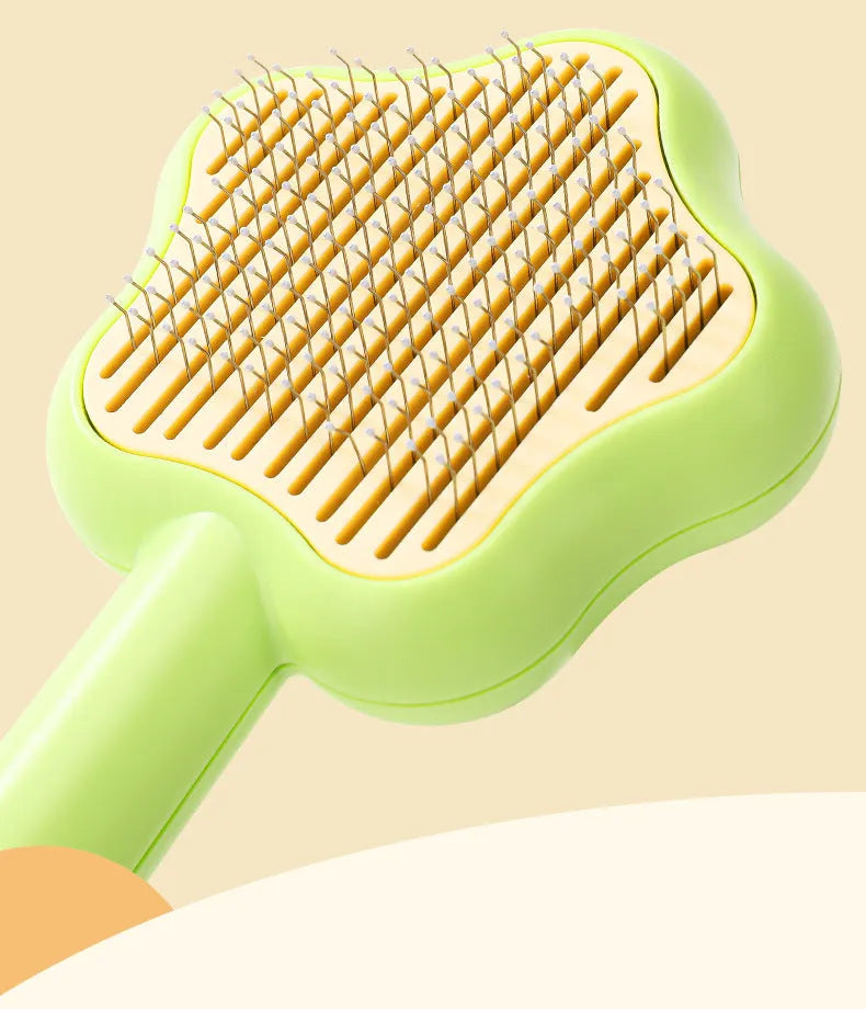 Green self-cleaning cat grooming comb with stainless steel needles and wand handle
