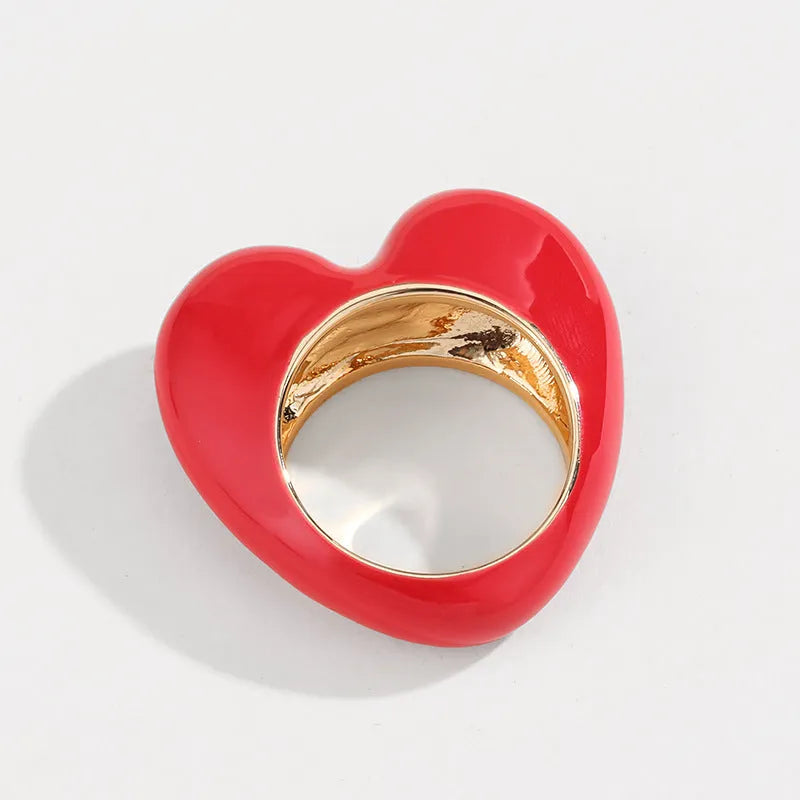 Close-up of a colourful three-dimensional enamel heart ring on a zinc alloy band.