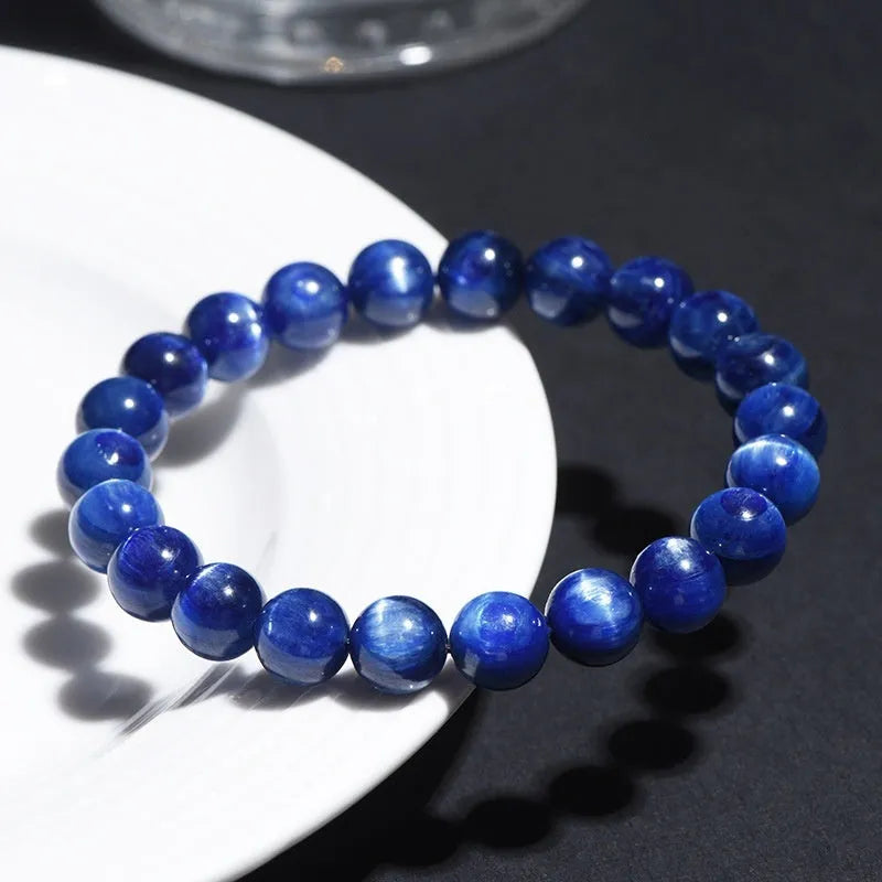 Natural blue grade 7A crystal bracelet with geometric bead and Ruyi charm on wrist.