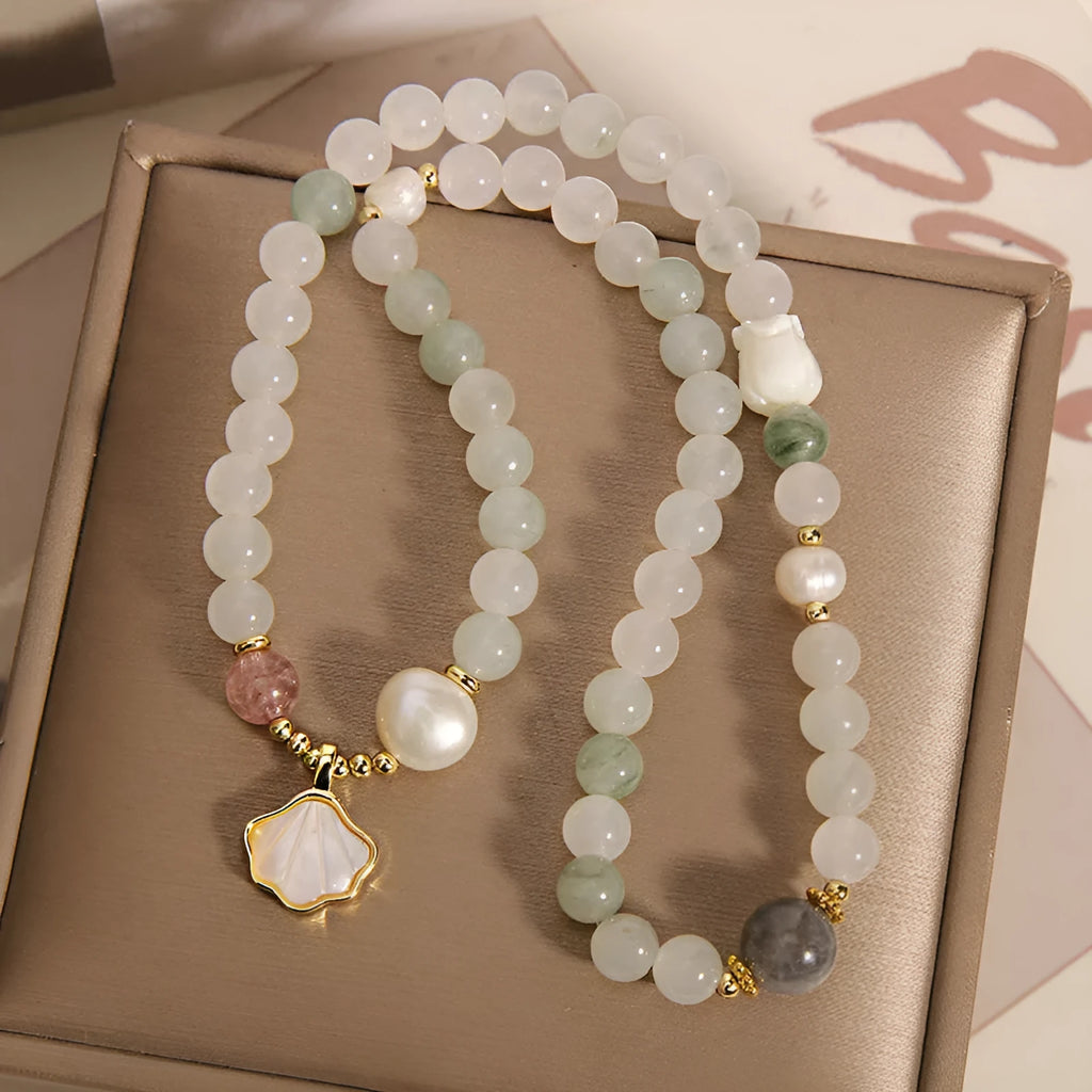 Women's crystal bracelet with a green Tianshan jade shell ginkgo leaf pendant, gold-plated accents, and rhinestones.