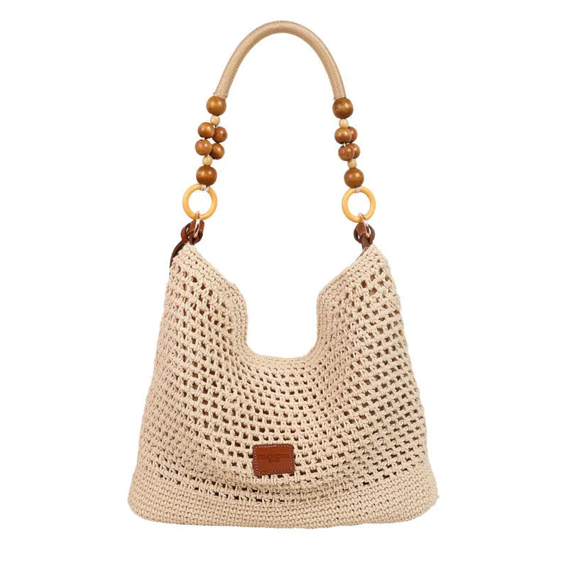 Knitted black large tote beach bag with bucket shape and contrast stitching.