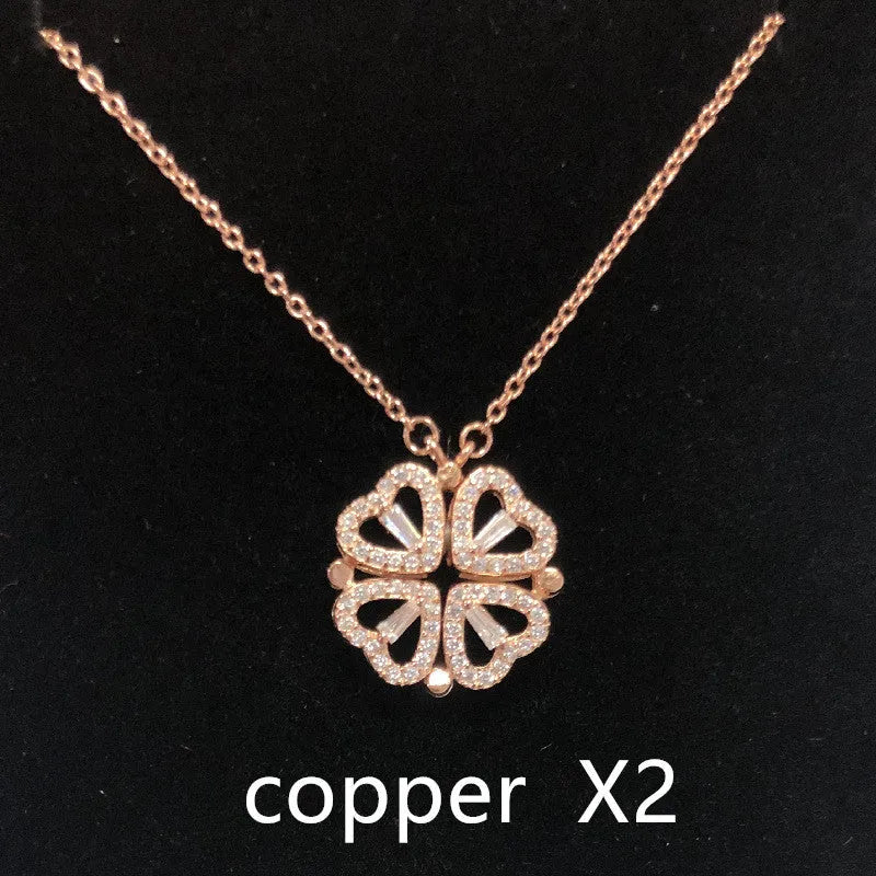 Heart shape four leaf clover pendant necklace in cupronickel 18K gold finish on white background