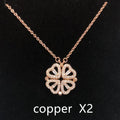 Heart shape four leaf clover pendant necklace in cupronickel 18K gold finish on white background