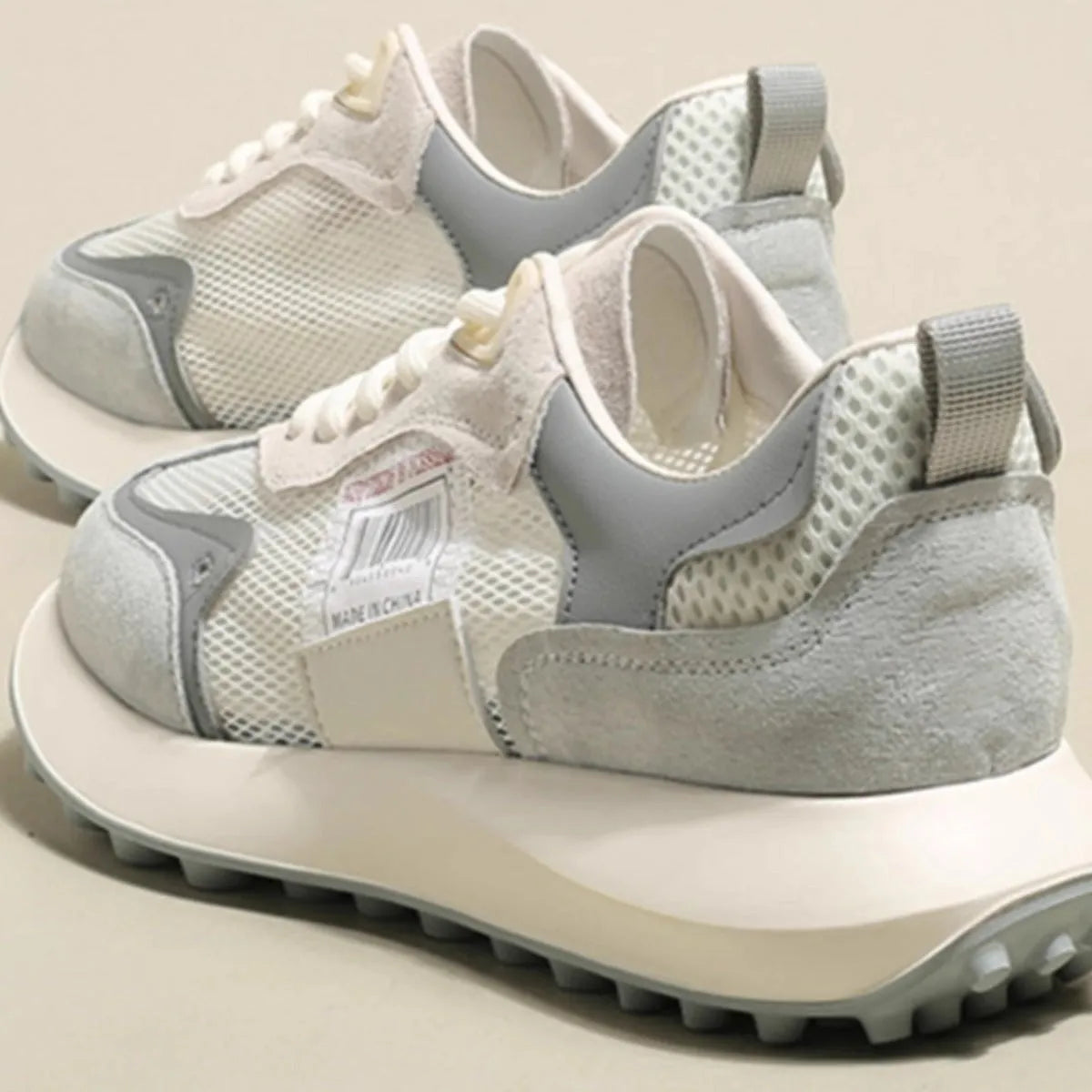 Women's grey and pink retro sneaker with low-top design and flat rubber sole