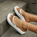 Thick bottom herringbone pattern flip-flops in multiple colours on a light background.