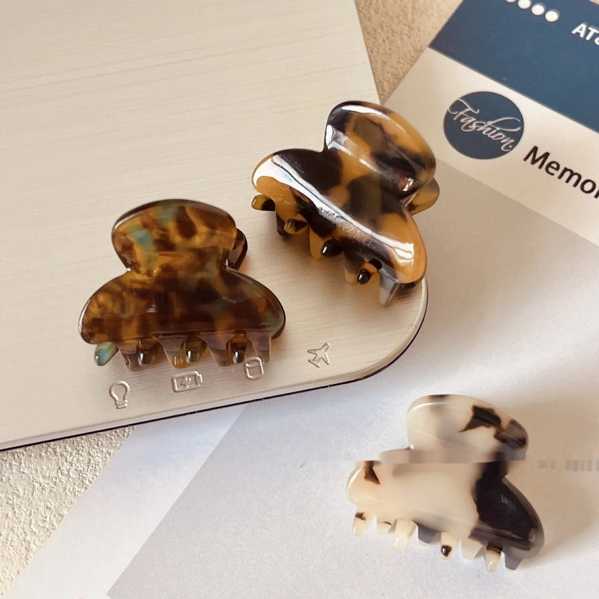 Mini jaw clip back head hairpin for women in acetic acid, shown in six colour options including coffee hawksbill and bright black.