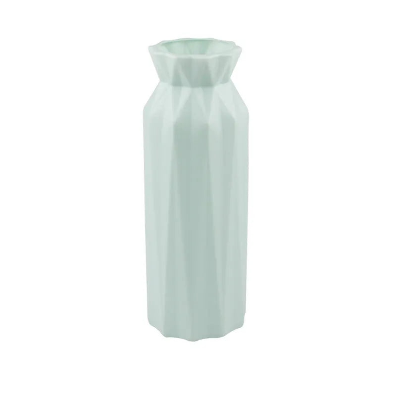 Green plastic melamine vase with a wide, stable base on a wooden surface.