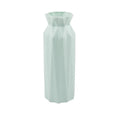 Green plastic melamine vase with a wide, stable base on a wooden surface.